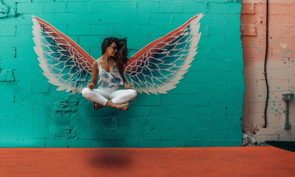woman taking picture beside wings decor 1328527