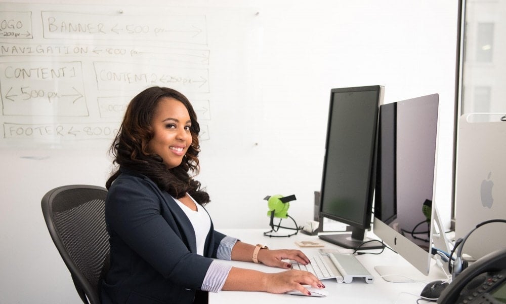 woman wearing black cardigan sitting on black mesh back 1181524