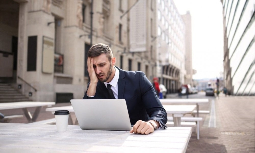man in black suit covering his face with right hand 3777554