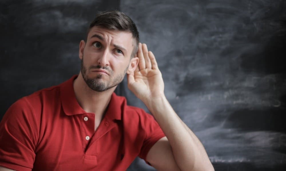 man in red polo shirt sitting near chalkboard 3779448