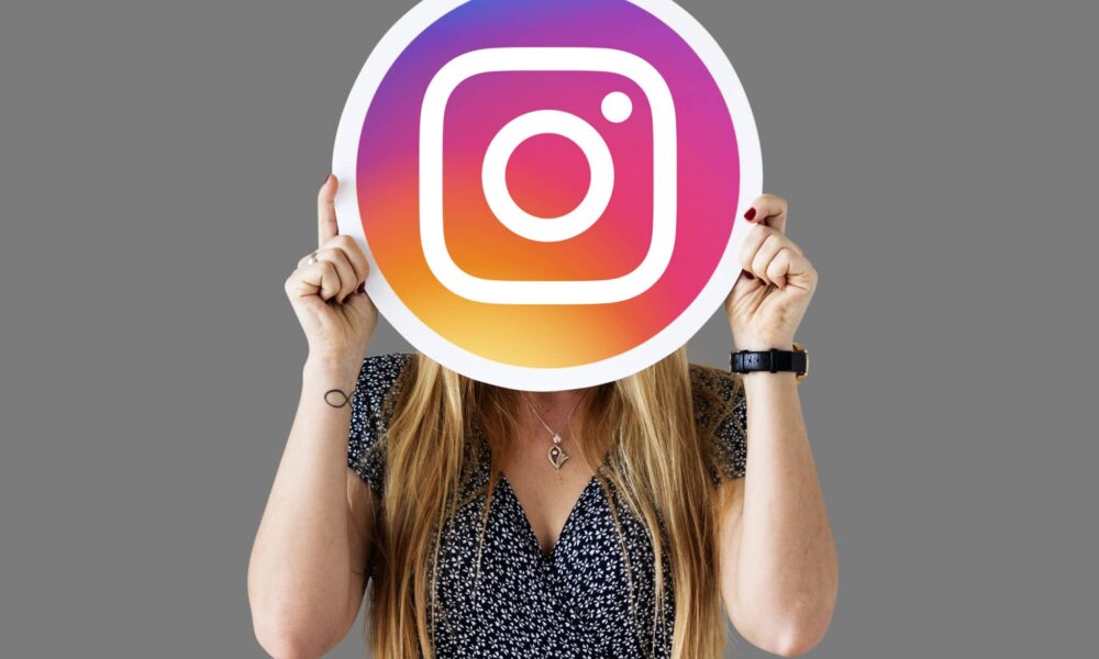 woman showing an instagram icon scaled