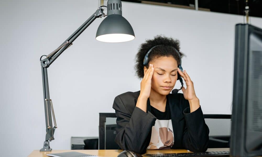 A Tired Woman Massaging Her Head