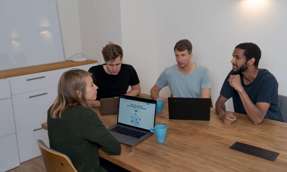 group of people sitting on chair in front of brown wooden table