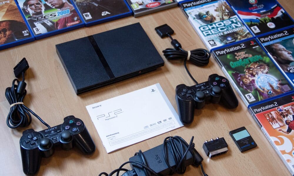black sony ps 4 game controller on brown wooden table