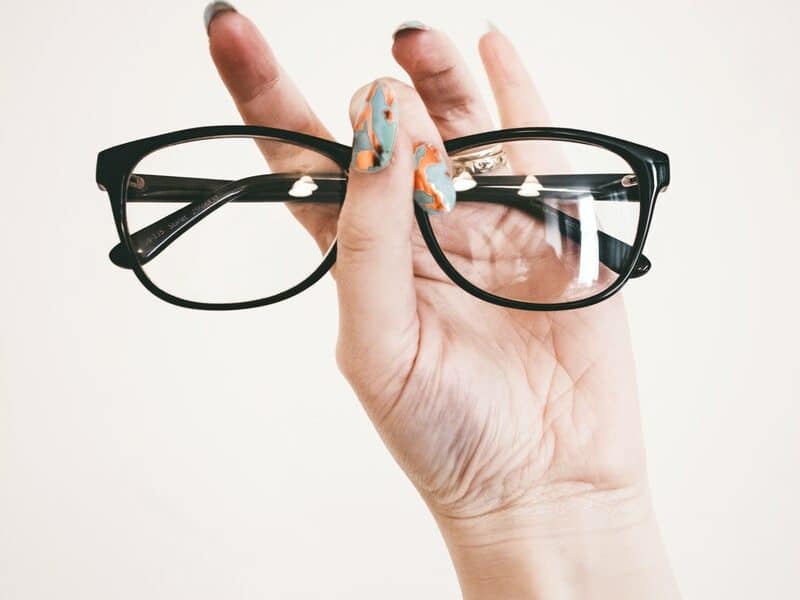 Photo of Person Holding Eyeglasses