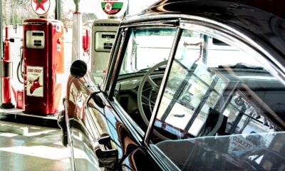 vintage black car parked near gas station
