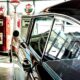 vintage black car parked near gas station