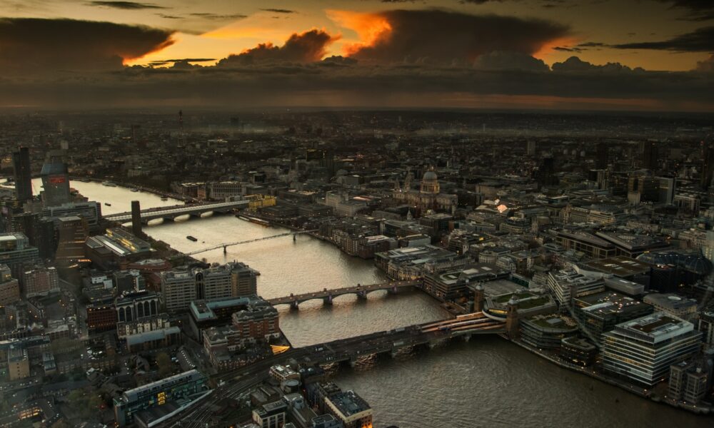 aerial photography of body of water between buildings during golden hour