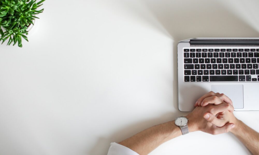 person wearing watch near laptop