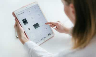Woman Sitting Beside Table While Using Ipad