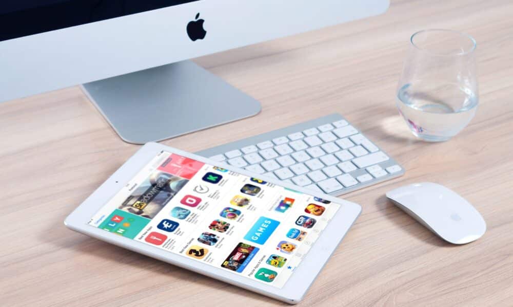 White Tablet Computer on Apple Magic Keyboard Near Apple Magic Mouse