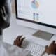 Person in White Long Sleeve Shirt Using Imac