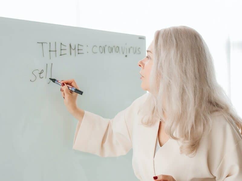 Teacher Writing on White Board