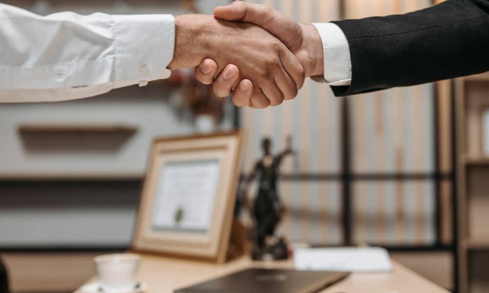Close Up Photo of People Shaking Hands