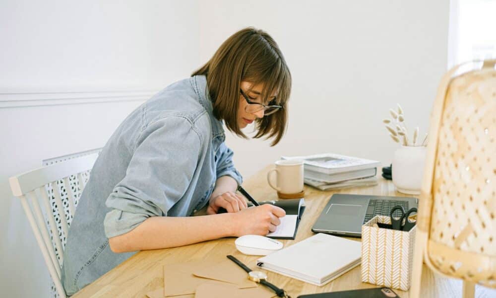 Woman Writing on a Notebook