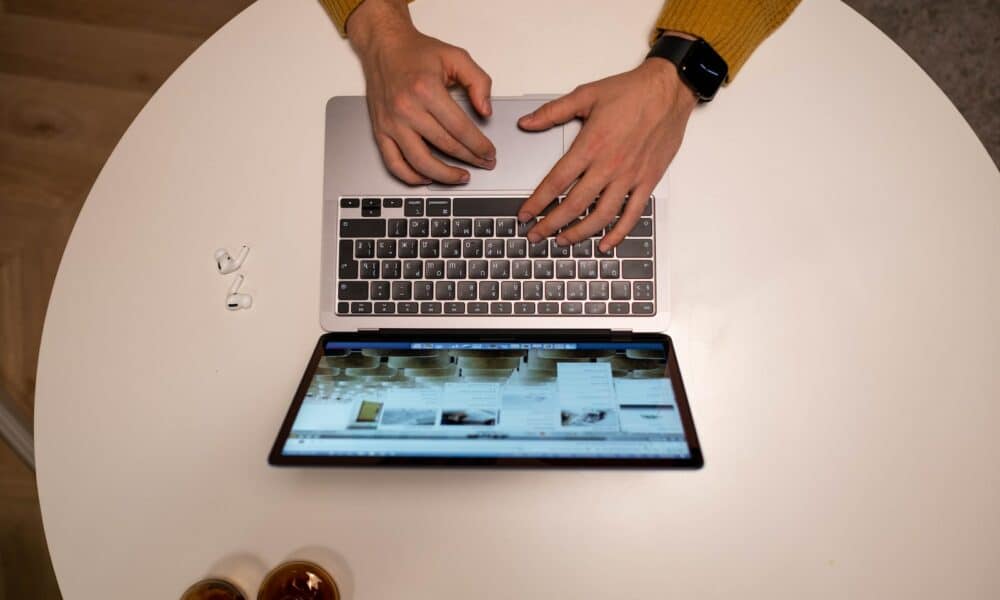 Person in Yellow Long Sleeve Shirt Using Macbook Pro