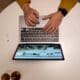 Person in Yellow Long Sleeve Shirt Using Macbook Pro