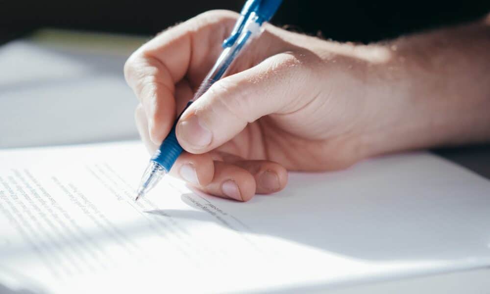 A Person Writing on a Paper