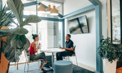 A Man and Woman Sitting on the Chair while Looking at Each Other