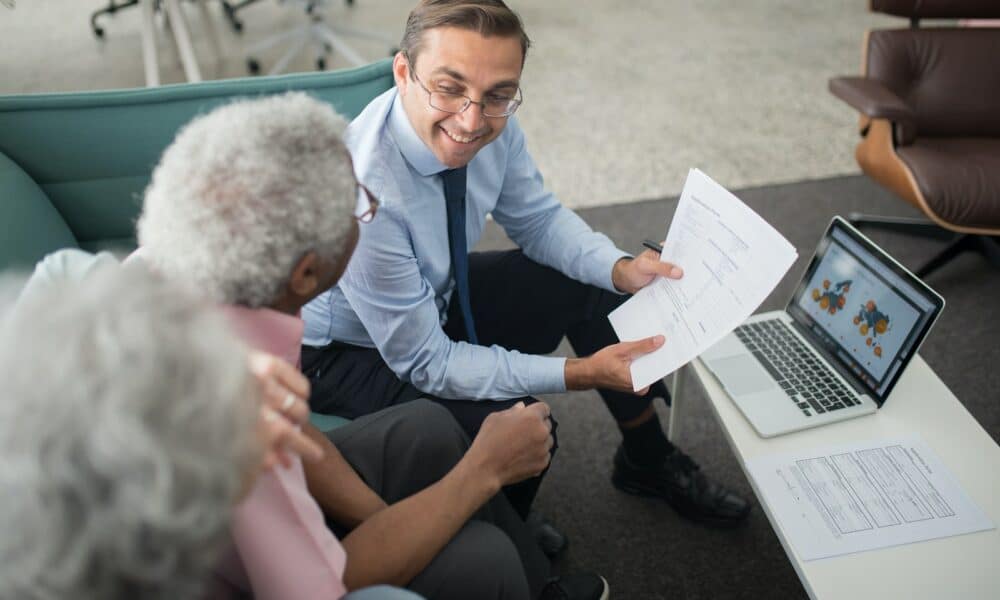 An Agent Showing Documents to an Elderly Man