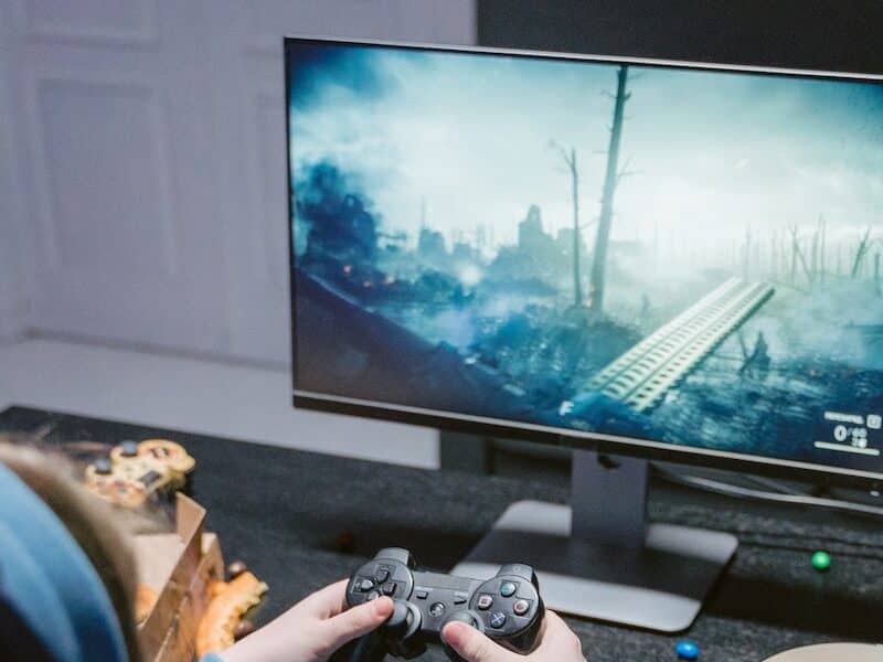 Black Flat Screen Tv Turned on Displaying Game