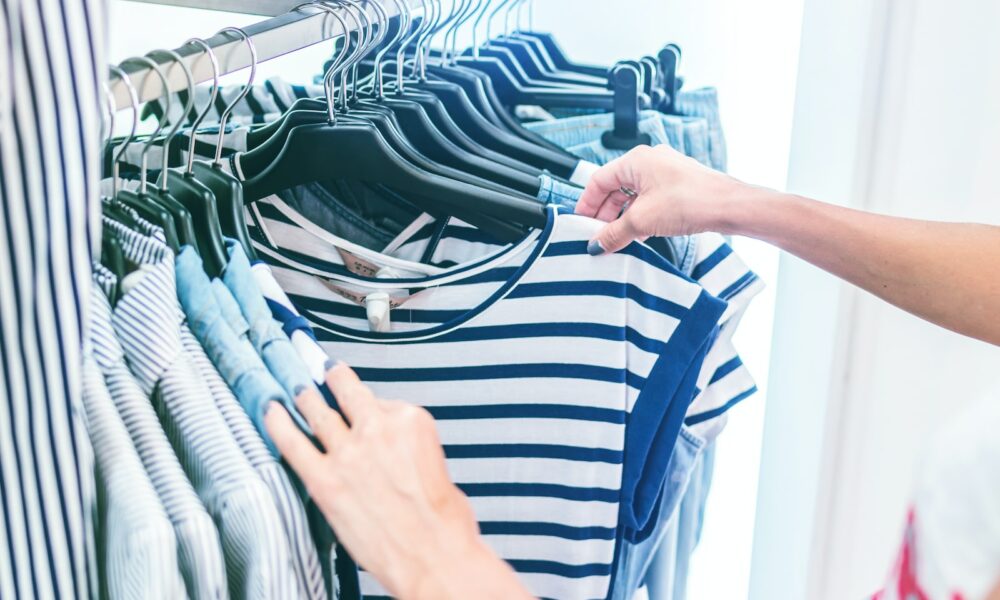 person holding white and black striped shirt