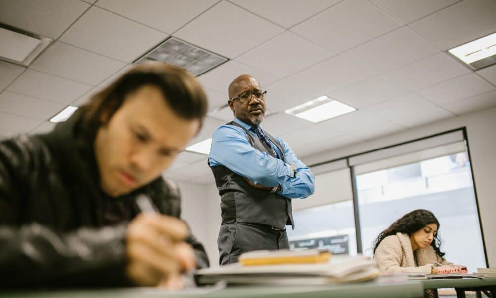 Teacher Proctoring His Students During an Examination