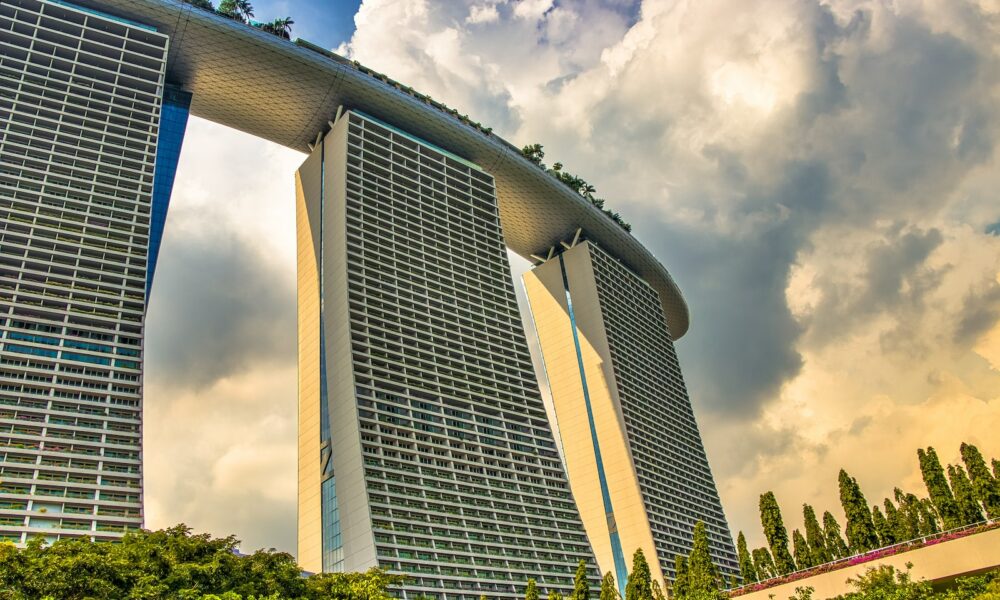 white and blue concrete building under white clouds during daytime