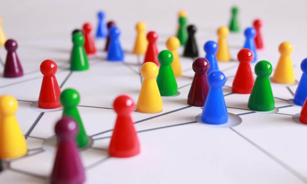 Close Up Photography of Yellow Green Red and Brown Plastic Cones on White Lined Surface