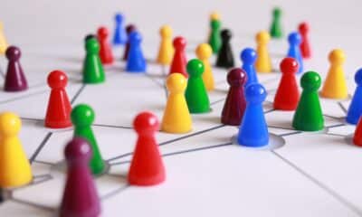 Close Up Photography of Yellow Green Red and Brown Plastic Cones on White Lined Surface