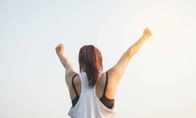 Woman Wearing Black Bra and White Tank Top Raising Both Hands on Top