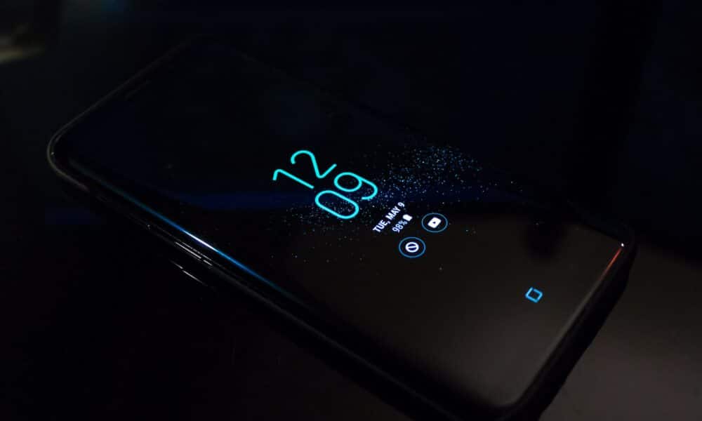 Turned-on Black Samsung Android Smartphone Displaying Clock at 12:09