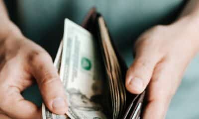 Crop man getting dollars from wallet