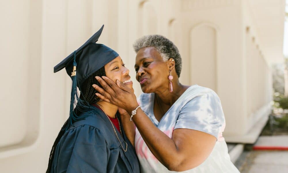 Proud Mother Kissing Her Daughter At Graduation