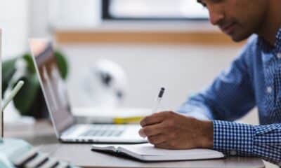 man, writing, laptop