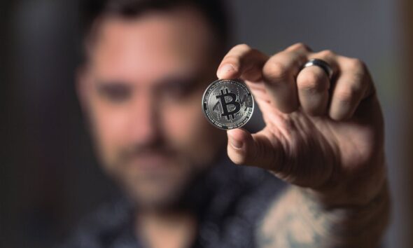 Person Holding Silver Bitcoin Coin