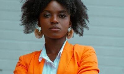 woman in orange blazer standing