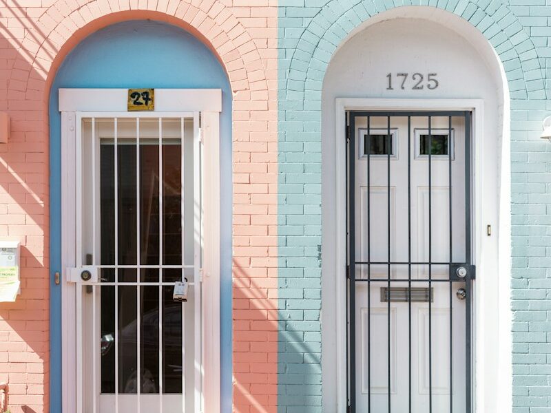two white wooden doors with grills