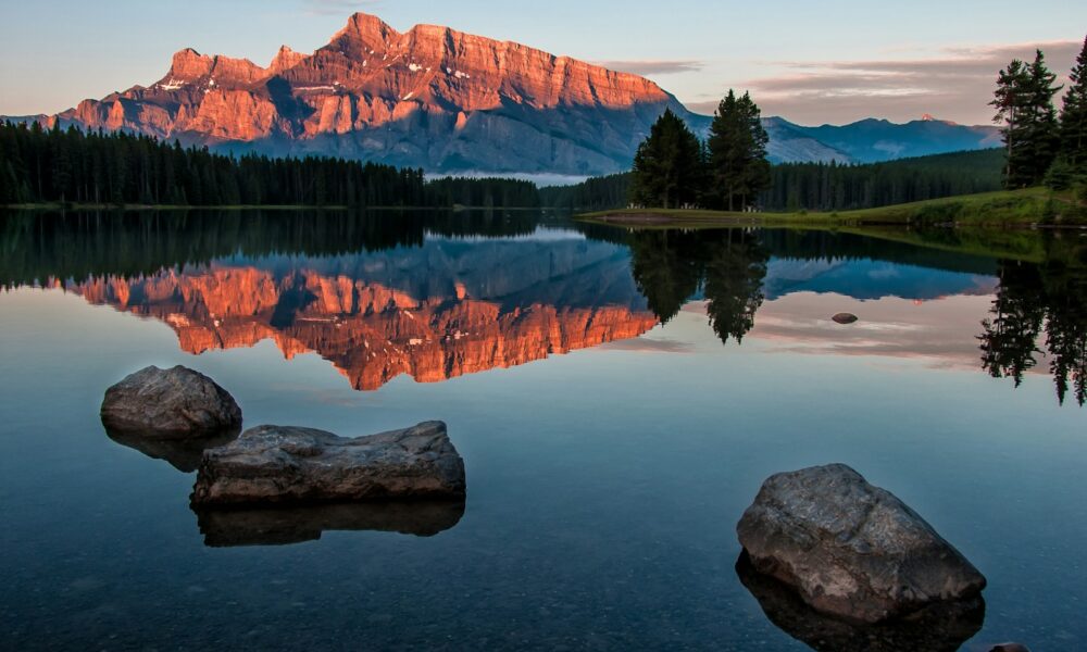 mountain reflection on body of water