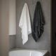 white bath towel on white ceramic bathtub