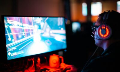 person using computer playing FPS game