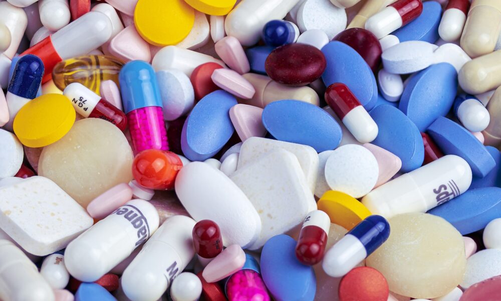 white blue and orange medication pill