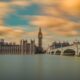 brown tower clock under cloudy sy