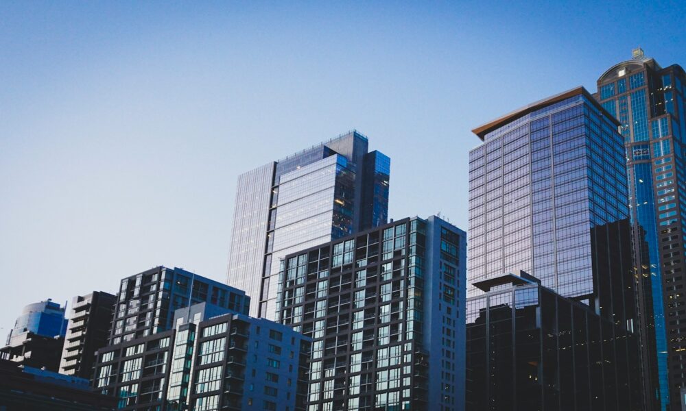 white and blue glass walled high rise building