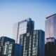 white and blue glass walled high rise building
