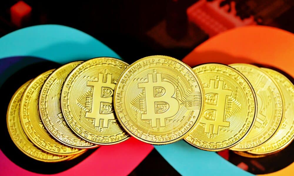gold round coin on red textile