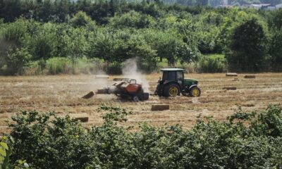red tractor on brown field during daytime