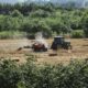 red tractor on brown field during daytime