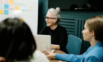 Smiling senior businesswoman leading a diverse team meeting in an office.