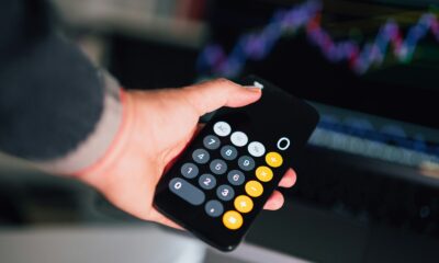 a person holding a remote control in their hand